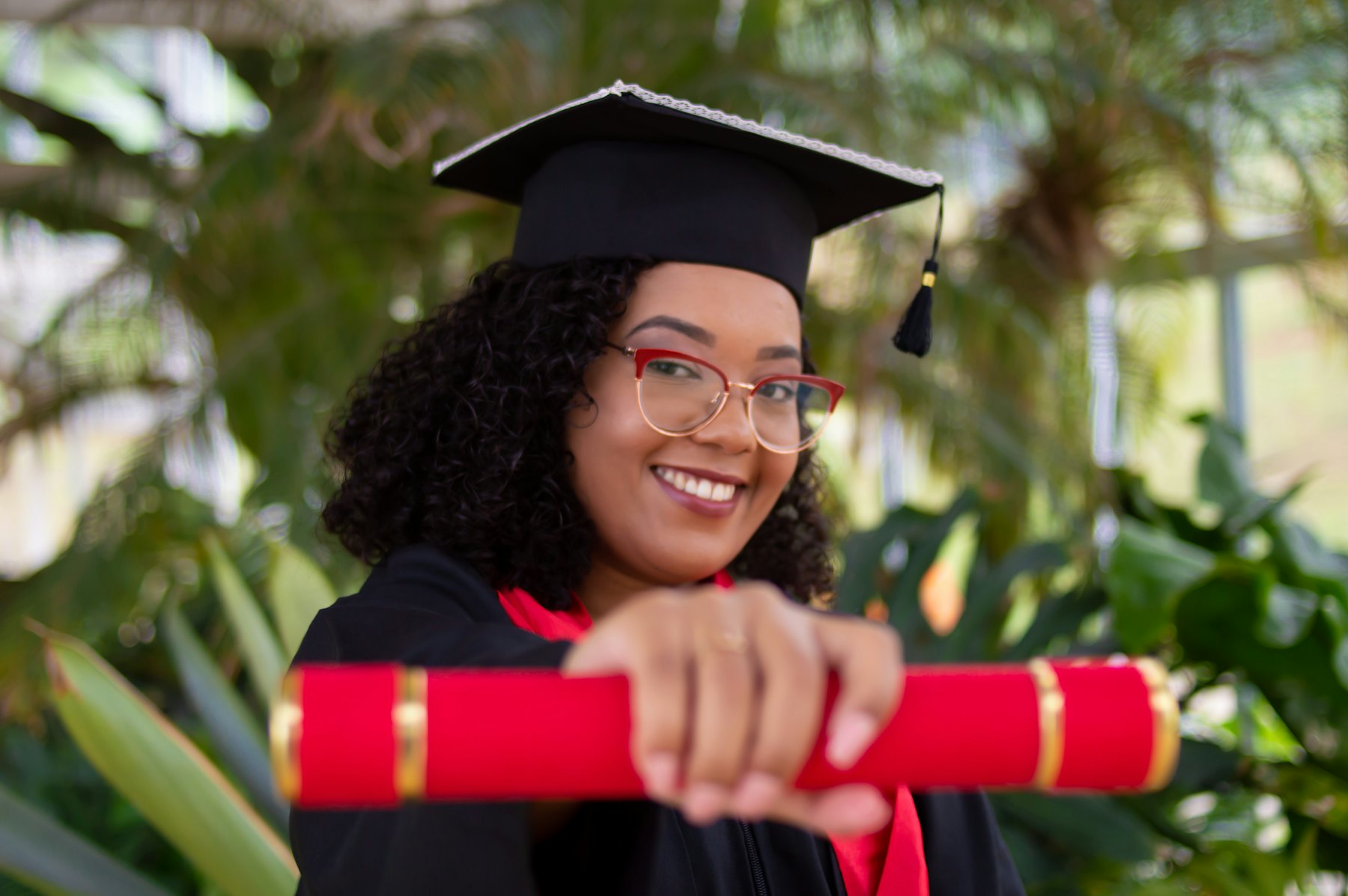 Smiling graduate holding her diploma